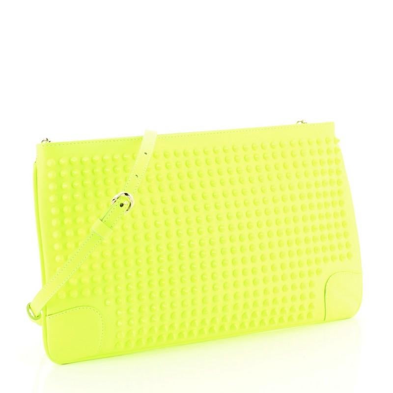 This Christian Louboutin Loubiposh Clutch Spiked Leather, crafted from green spiked leather, features a removable chain and leather shoulder strap, red enamel Louboutin logo zipper pull, and gold-tone hardware. Its zip closure opens to a red fabric