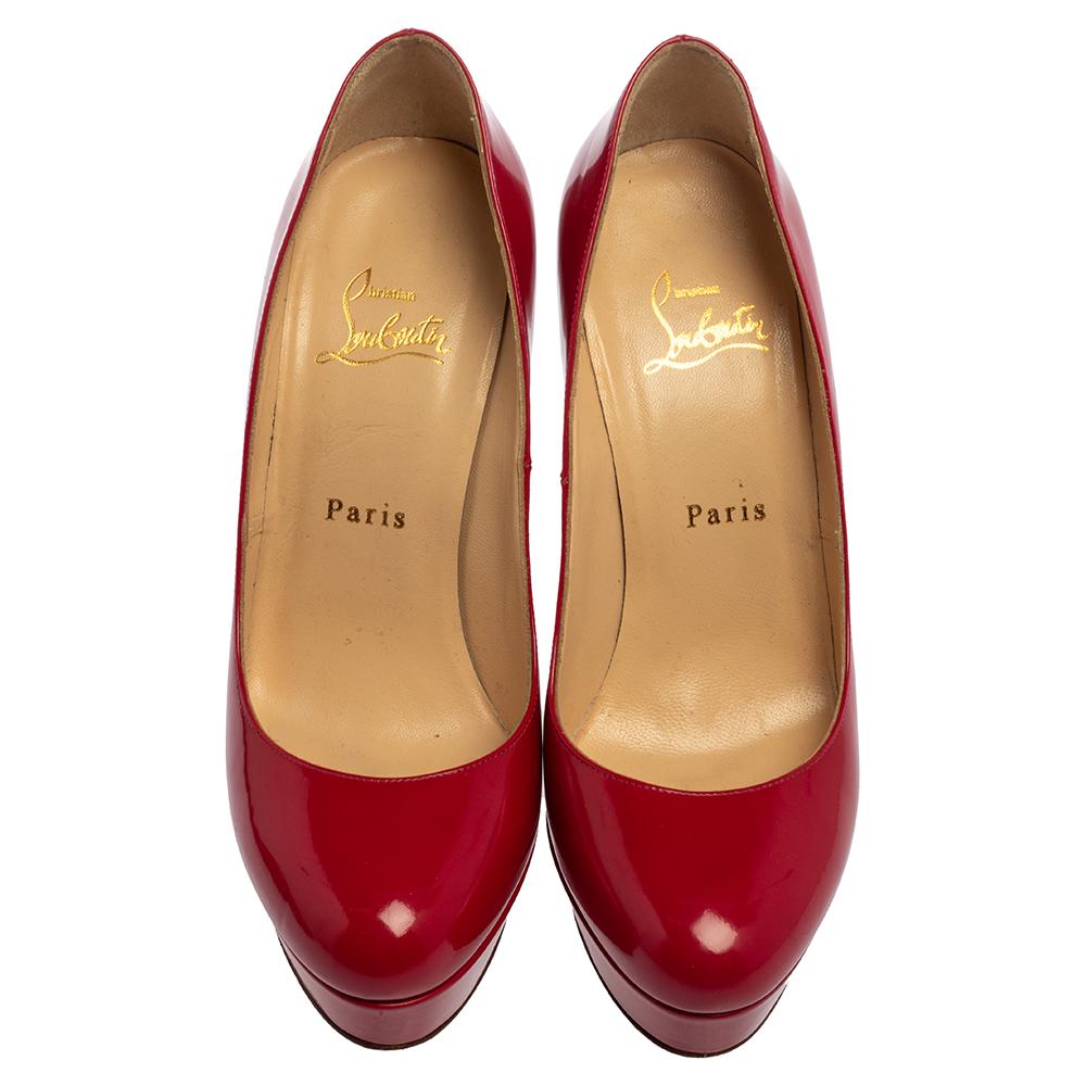 A classic to add to one's shoe collection is this pair. These Christian Louboutin beauties are covered in magenta-hued patent leather and styled with platforms, 13 cm heels, and the signature red soles. Add these pumps to your closet today and