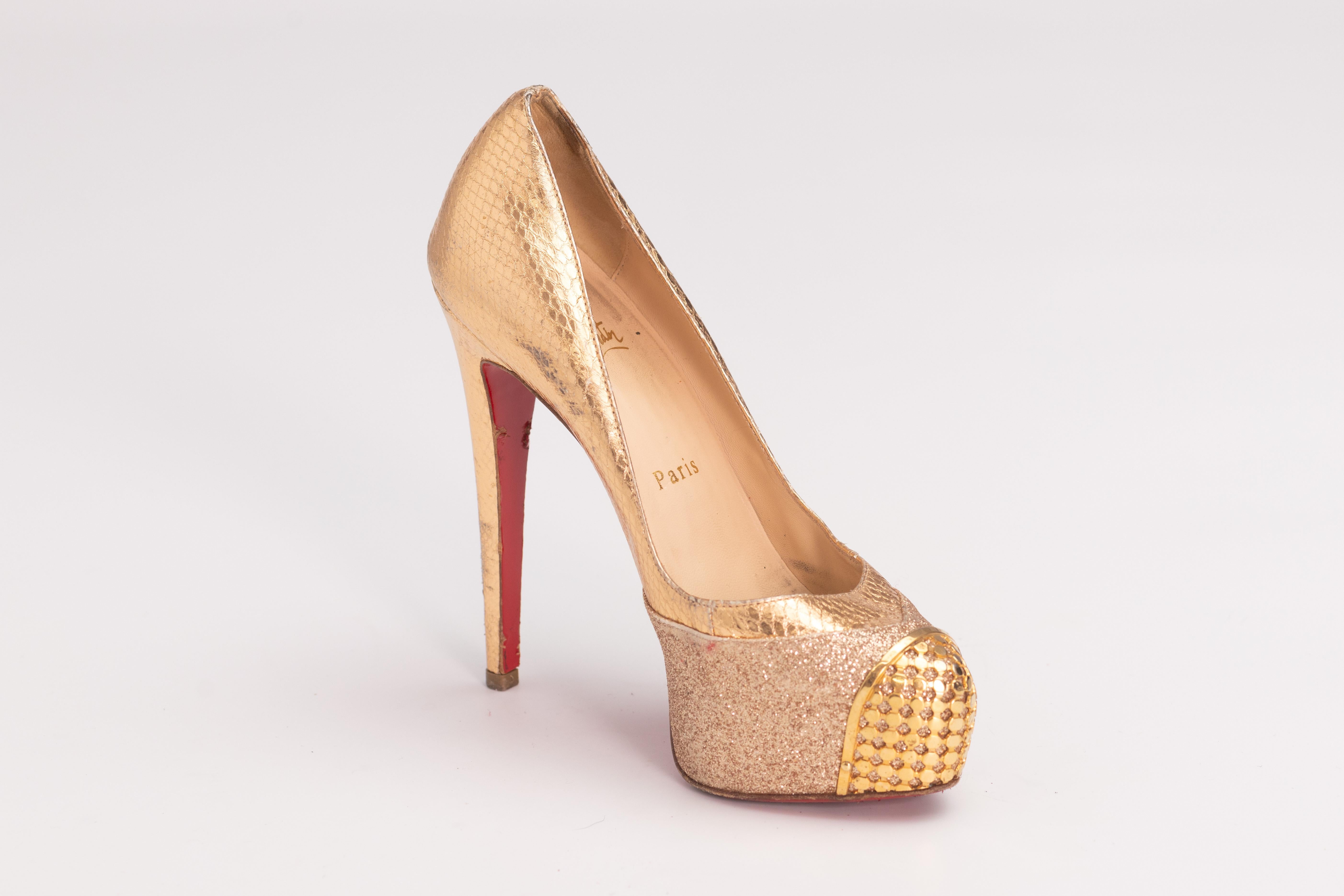 CHRISTIAN LOUBOUTIN MAGGIE GLITTER & SNAKESKIN PLATFORM HEELS (EU 36)

Color: Gold
Material: Snake skin, glitter with metal toe detail 
Size: 36 EU / X US
Heel Height:  125 mm / 5”
Platform Height: 25 mm / 1” 
Condition: Good. Scratches, scuffs and