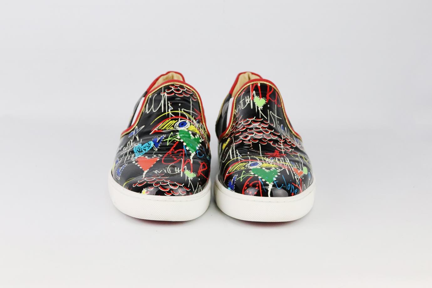 Christian Louboutin Masteralta printed patent leather slip on sneakers. Made from black and multicoloured graffiti-print in a classic slip-on sneaker style on the brand’s iconic red sole. Black, white, red and gold. Slip on. Does not come with box