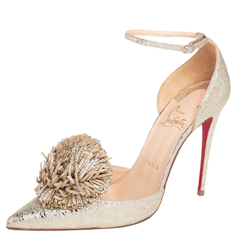 Christian Louboutin yet again brings a stunning set of Tsarou pumps that makes us marvel at its beauty and craftsmanship. Crafted from crinkled leather in a metallic gold shade, they have been adorned with pompoms on the uppers, pointed toes, and