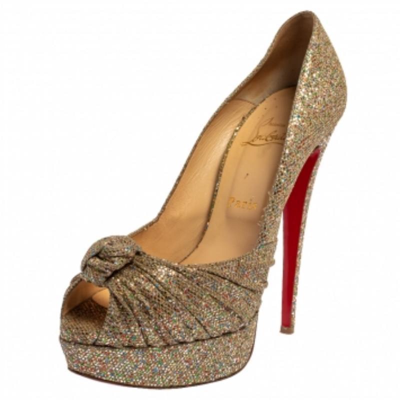 How gorgeous are these pumps from Christian Louboutin! They've been beautifully covered in glitter fabric and styled in a gathered knot on the uppers. These pumps carry peep-toes, platforms with 14.5 cm heels, and the signature red soles. Let this