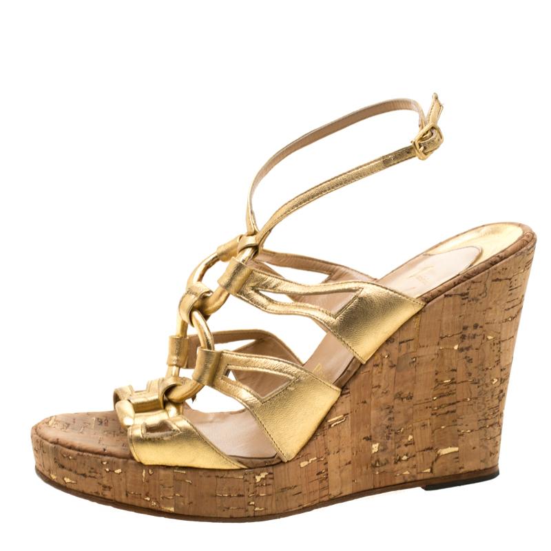 Wear these Christian Louboutin sandals for a comfortable feel with a touch of glam. These beautifully crafted leather sandals feature gold ring motifs linked to ankle straps and 11 cm cork wedge heels. The padded insoles are lined with leather and