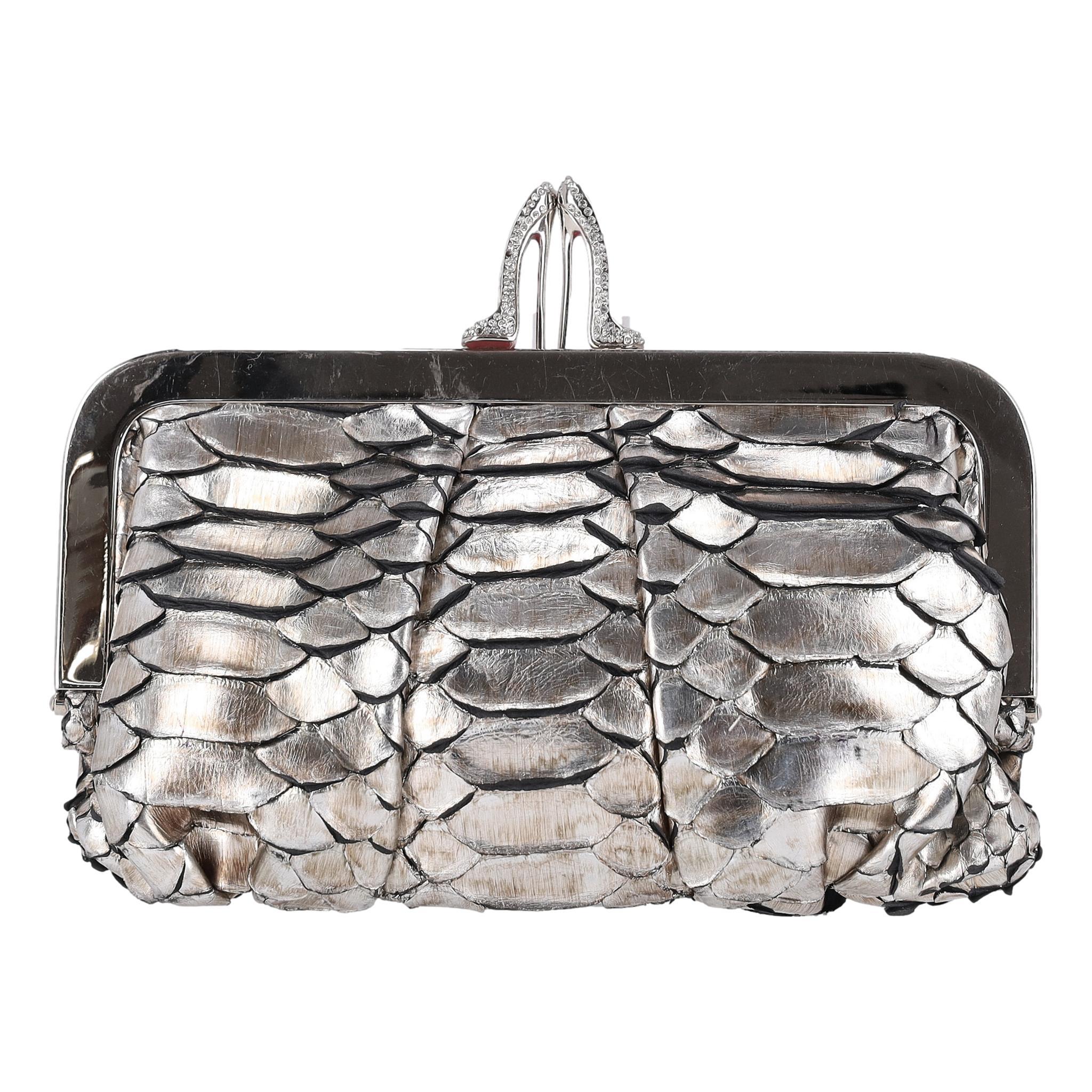 Christian Louboutin Metallic Python Skin Loubi Lula Mini Frame Clutch Bag

Metallic silver Loubi Lula clutch bag crafted from python skin.

Featuring crystal embellished silver High Heels shaped closure.

Styled with red interior with slip