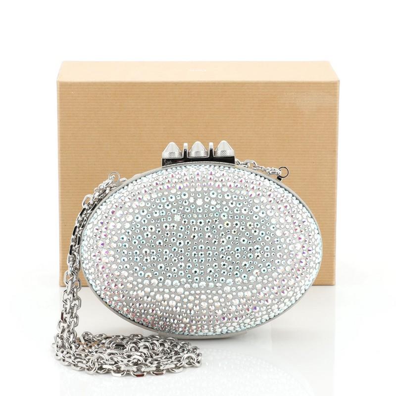 This Christian Louboutin Mina Clutch Strass, crafted silver crystal embellishment satin, features a rounded silhouette, a detachable chain strap and silver-tone hardware. Its clasp closure opens to Louboutin's red leather interior 
Condition: Very
