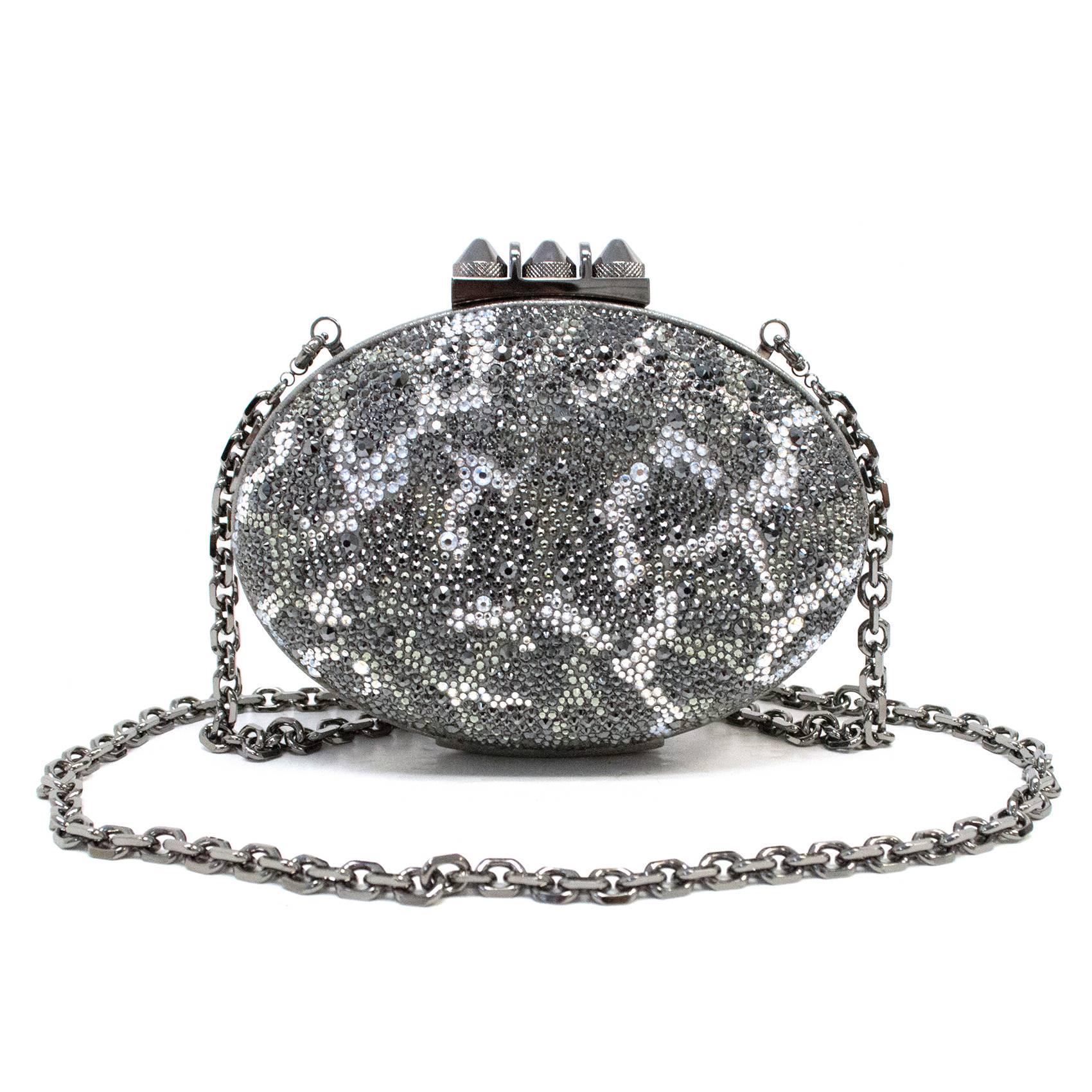 Christian Louboutin Mina Clutch Strass Leopard/Suede Burma from the current season collection. It is designed in a leopard print pattern with grey swarovski crystals, silver studded buckle and detachable silver chain strap handle. This is a very