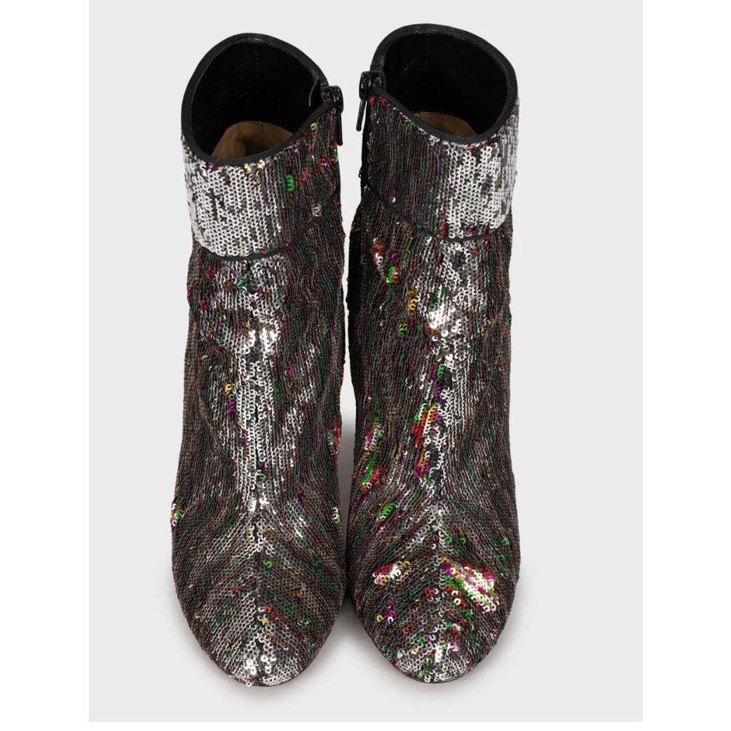 Mettez le paquet avec ces bottines emblématiques Christian Louboutin Moulamax ! Ces bottes sont fabriquées en cuir de haute qualité et présentent des paillettes chatoyantes qui attirent le regard. Avec leur bout rond, leur fermeture éclair latérale