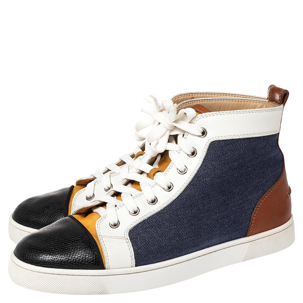 A pair that will see you through a long day in full comfort! Crafted using denim, suede, and leather, these Christian Louboutin sneakers are designed in a high-top style with lace-up closure along the front. The sneakers are finished with the