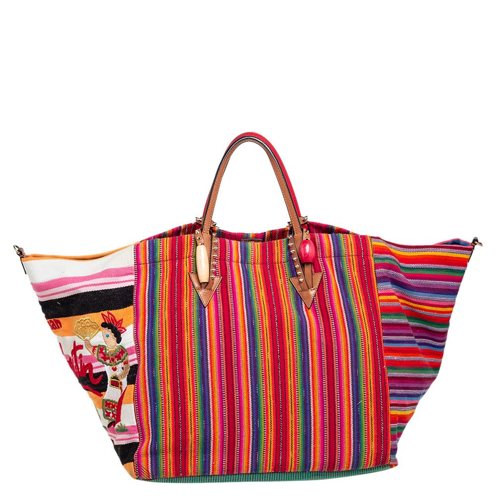 Rich hues, pretty embellishments, and gorgeous patterns bring out the charm of this Christian Louboutin Mexicaba tote. Made of fabric, the bag is equipped with two top handles and a shoulder strap. It has a spacious size to easily assist you on busy