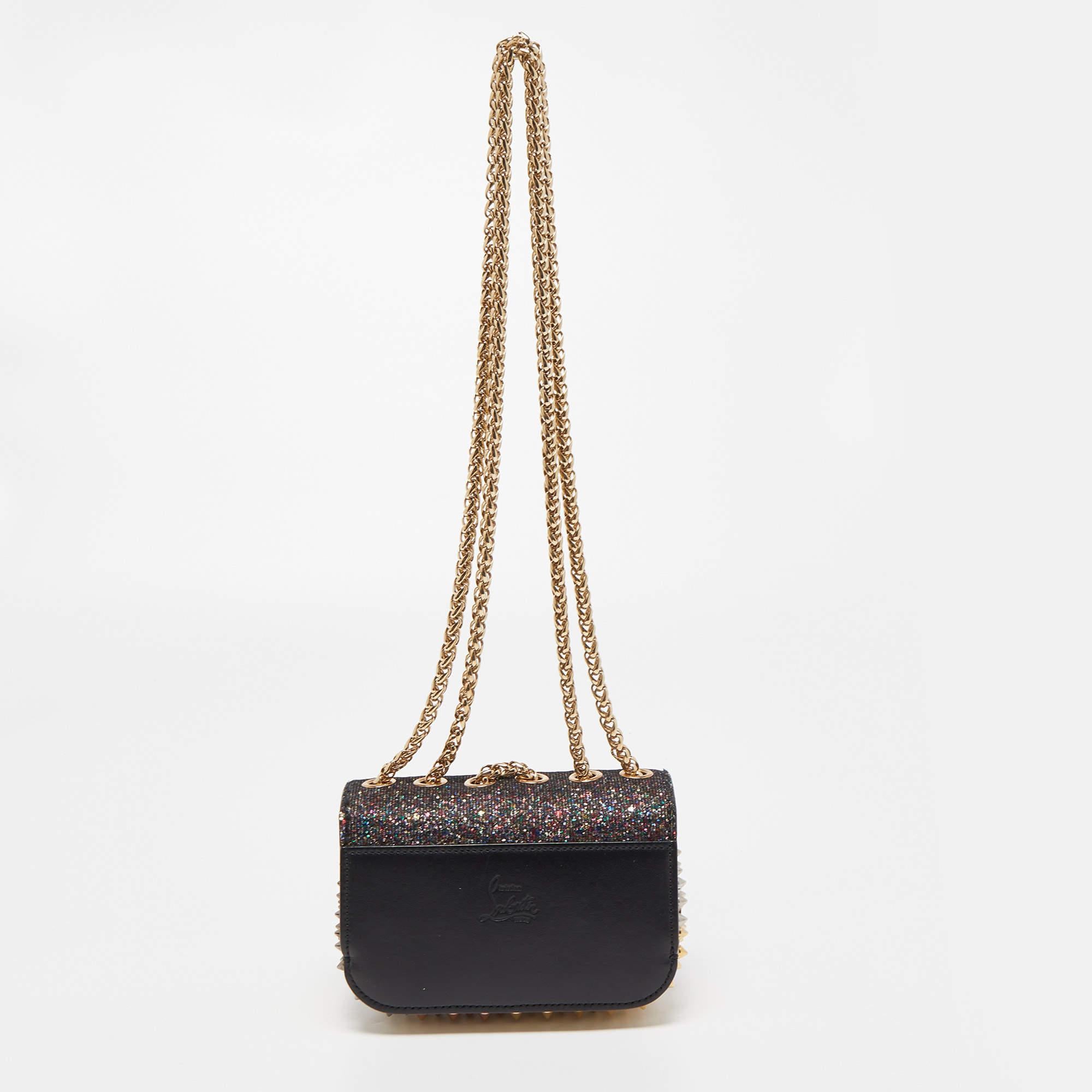 This modern and edgy Sweet Charity bag is from Christian Louboutin. Crafted from multicolor glitter, the bag comes with eye-catching spike embellishments . The insides are suede-lined and the bag is complete with a chain strap. Invest in this superb