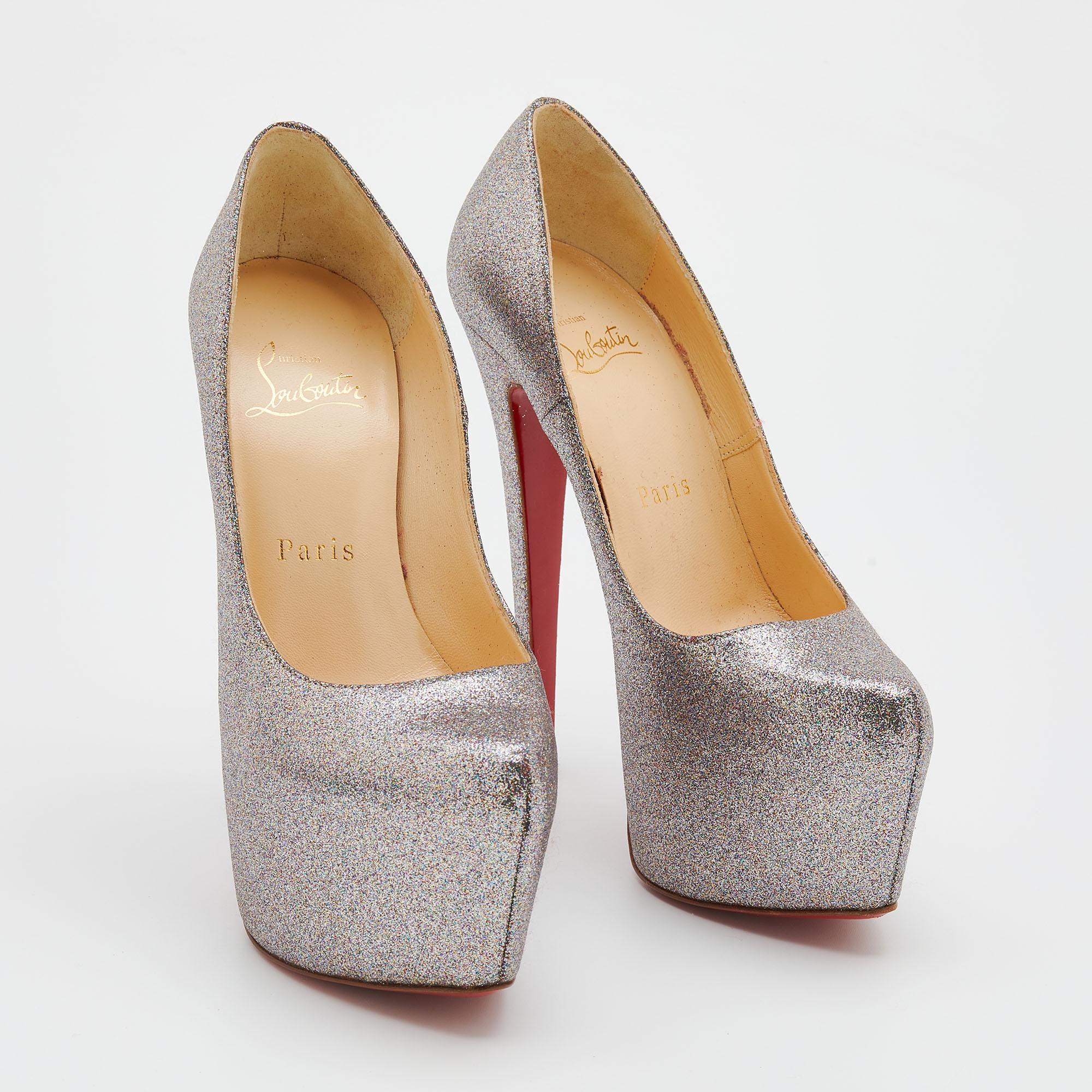 Take your love for Louboutins to new heights by adding this gorgeous pair to your collection. The stunning pumps are covered in glitter and elevated on platforms and 15 cm heels. The red soles add the signature finish that CL is loved for!

Includes