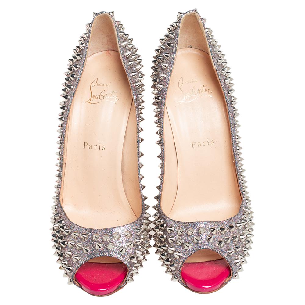 Stand out from the crowd with this gorgeous pair of Louboutins that exude high fashion with class! Crafted from multicolor glitter fabric, this is a unique creation. They feature peep-toes and multiple spikes embellished on the exterior. Completed