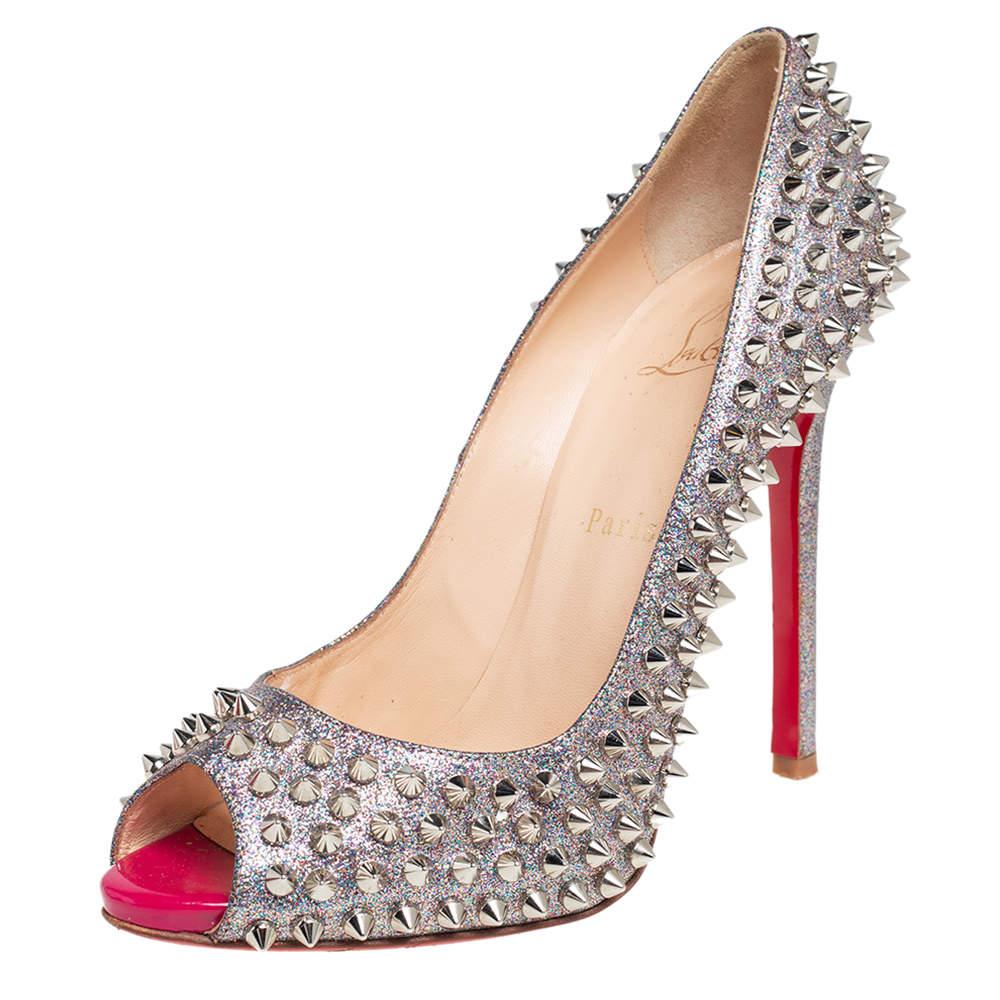 Stand out from the crowd with this gorgeous pair of Louboutins that exude high fashion with class! Crafted from multicolor glitter fabric, this is a unique creation. They feature peep-toes and multiple spikes embellished on the exterior. Completed