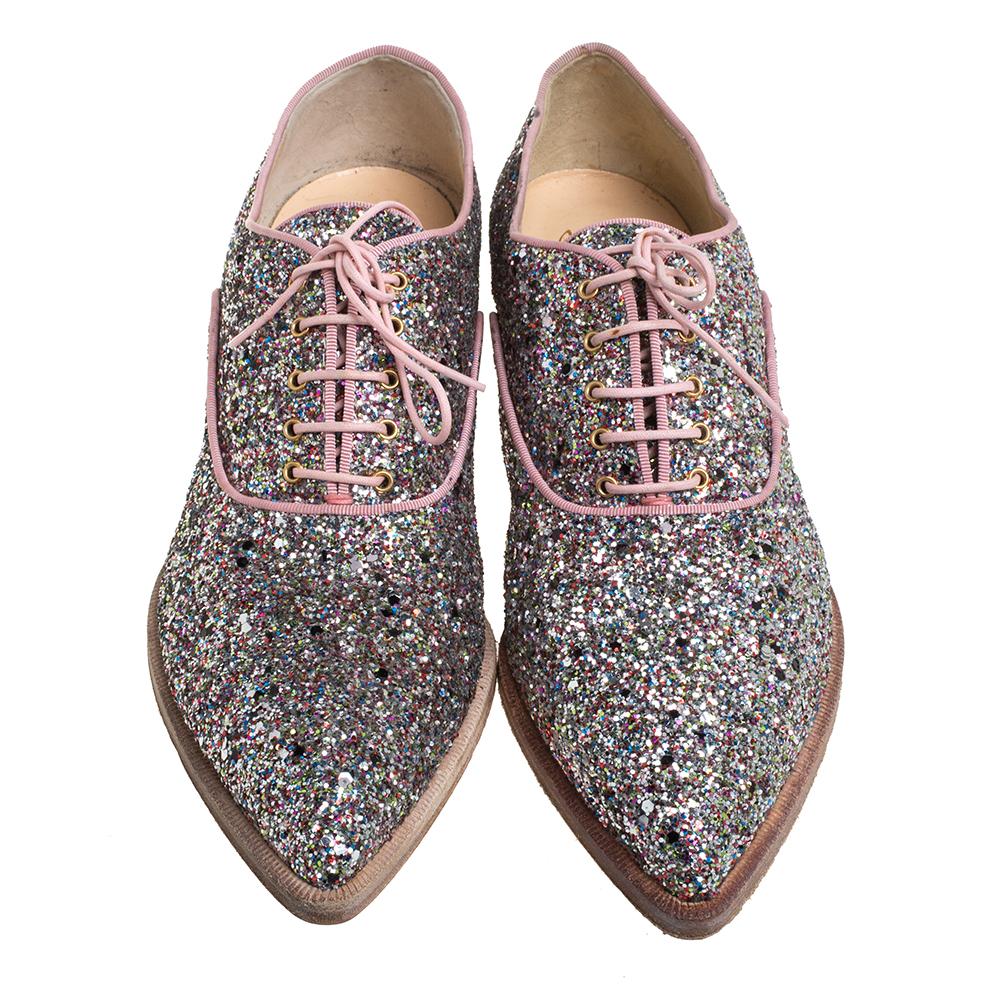Oxfords never looked so glamorous, thanks to these ones from Christian Louboutin! Clothed in multicolor glitter, they feature pointed toes, lace-ups on the vamps, and short heels. They are endowed with comfortable leather-lined insoles and finished