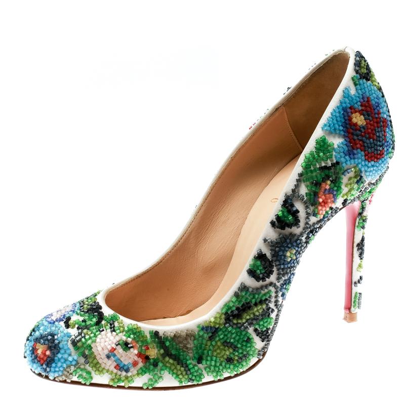 Flaunt the latest fashion with this pair of high-end pumps designed by Christian Louboutin. Hand-decorated with colourful beads on the satin exterior, these pumps will make all heads turn. They are finished with red soles and 10.5 cm