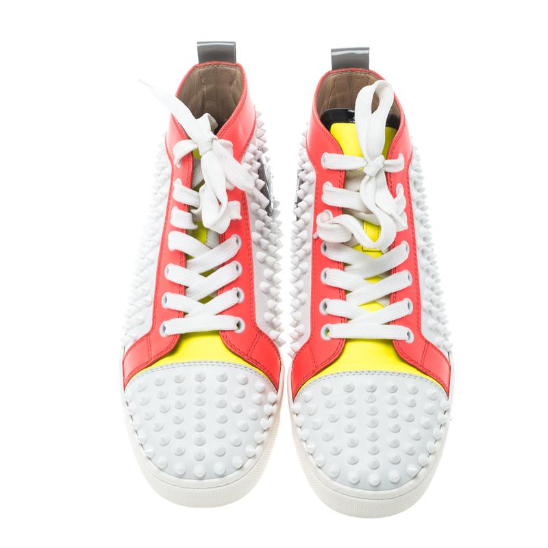 Fall in love with casual wear every time you step out in these sneakers from Christian Louboutin. They've been crafted from different shades of leather and styled as a high top with an exterior wonderfully lined with spikes. The sneakers carry round