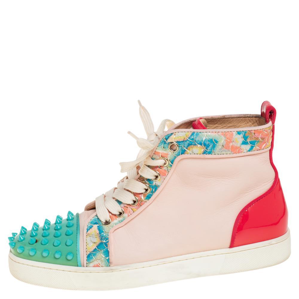 Feel great in your casual wear every time you step out in these sneakers from Christian Louboutin. They have been crafted using leather and styled as a high top with detailing of spikes, snake-embossed trims, and patent leather on the counters. The
