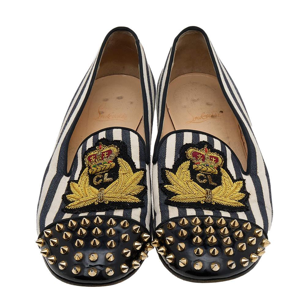 One look at this pair from Christian Louboutin and you'll know what your shoe collection has been missing all along! Crafted with excellence in patent leather and canvas, these Harvanana smoking slippers are simply luxe. Spike embellished cap toes,