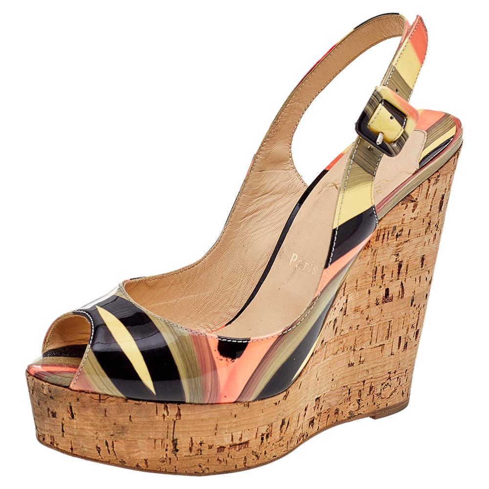These Une Plume sandals from Christian Louboutin will bring elegance and class to your attire. They are made from multicolored patent leather and feature peep-toes, cork-wedge heels, and a slingback. They are adorned with silver-toned hardware and