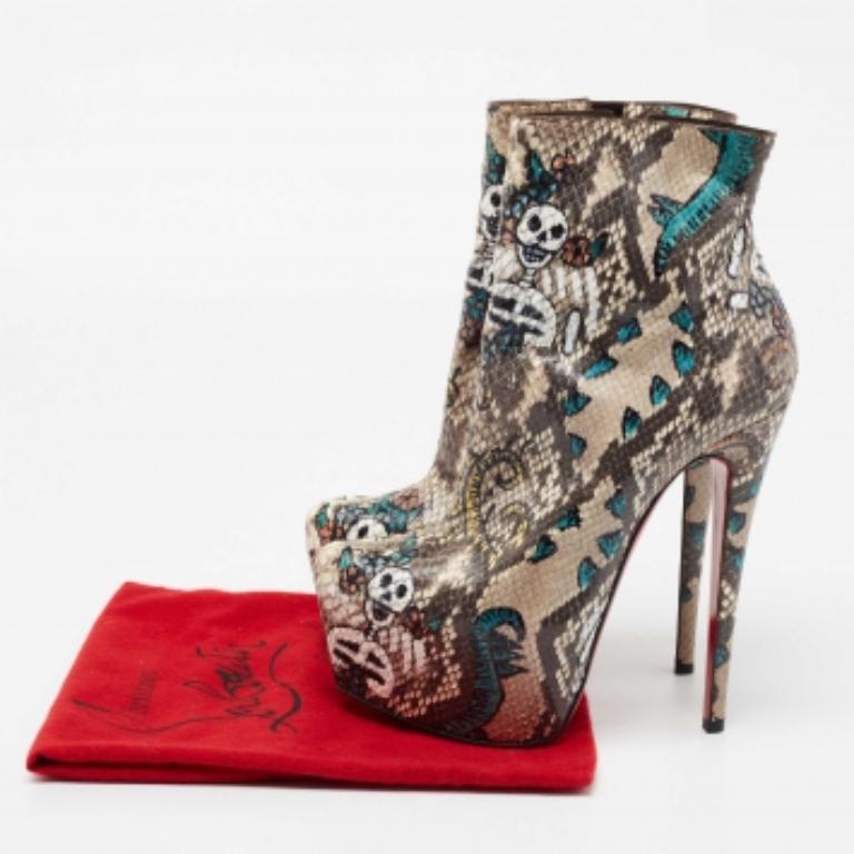 Flaunt never-ending luxury and elegance in these fabulous boots from Christian Louboutin. They are created using multicolored python skin on the exterior into an ankle-length silhouette. They showcase 16 cm heels, platforms, and brown-tone hardware.