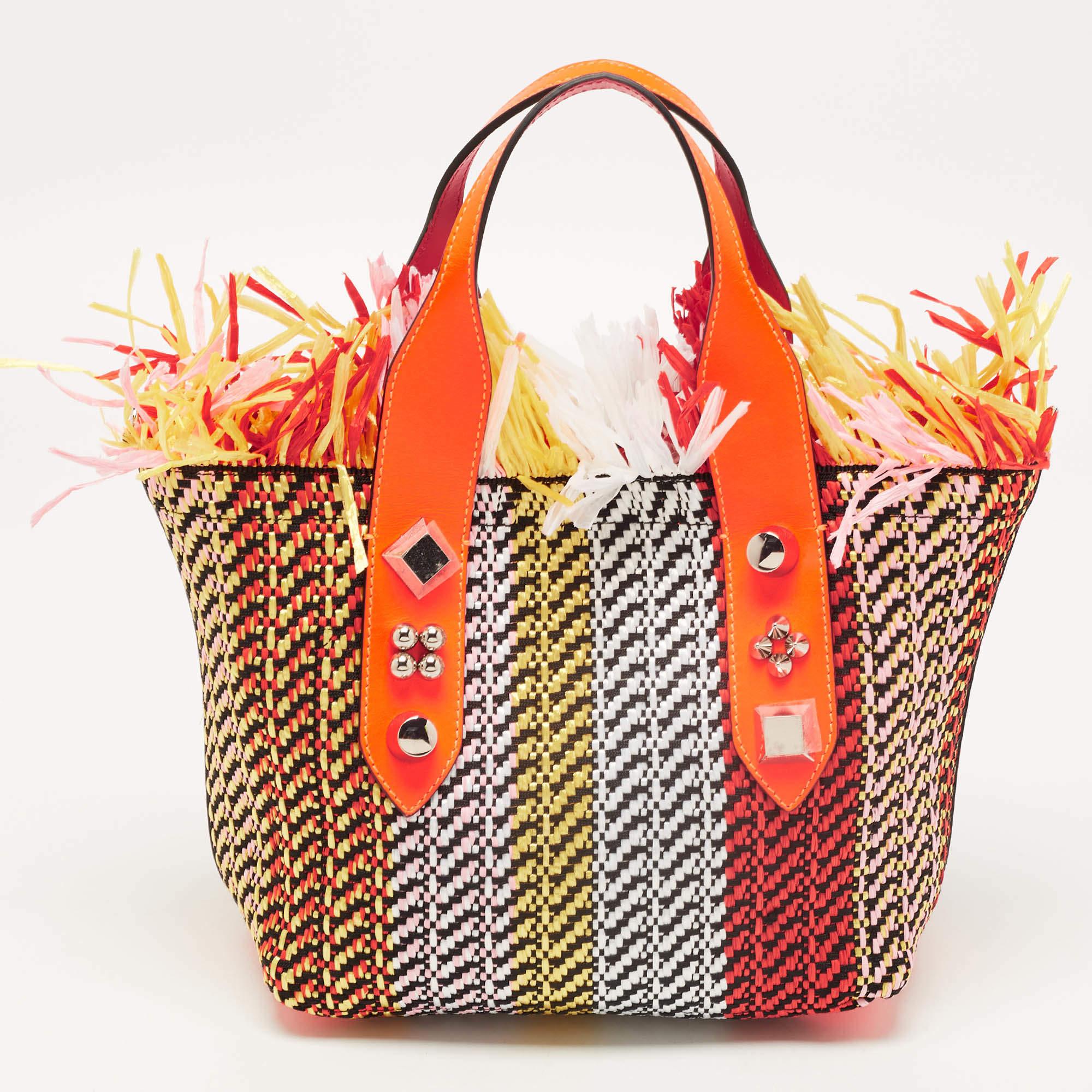 The Christian Louboutin Frangibus tote is a stylish and eye-catching accessory. It features a combination of straw and leather materials in a vibrant multicolor design. The tote is adorned with small fringes, adding a touch of playfulness and