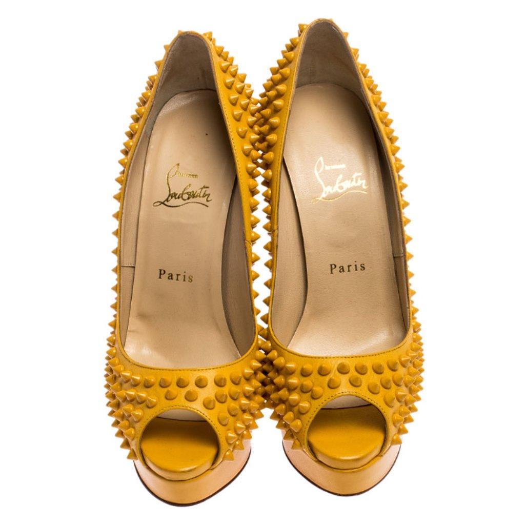 Stand out from a crowd with this gorgeous pair of Louboutins that exude high-fashion with class! Crafted from leather, this is a creation from their Lady Peep collection. They feature a mustard shade with peep toes and a spike-detailed exterior.