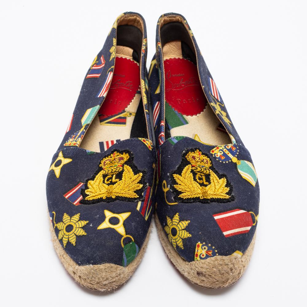 Christian Louboutin brings you these super-stylish espadrille loafers for that ultimate casual look. These quirky and fun loafers have been crafted from printed canvas and designed with an embroidered crest on the uppers. Braided midsoles and