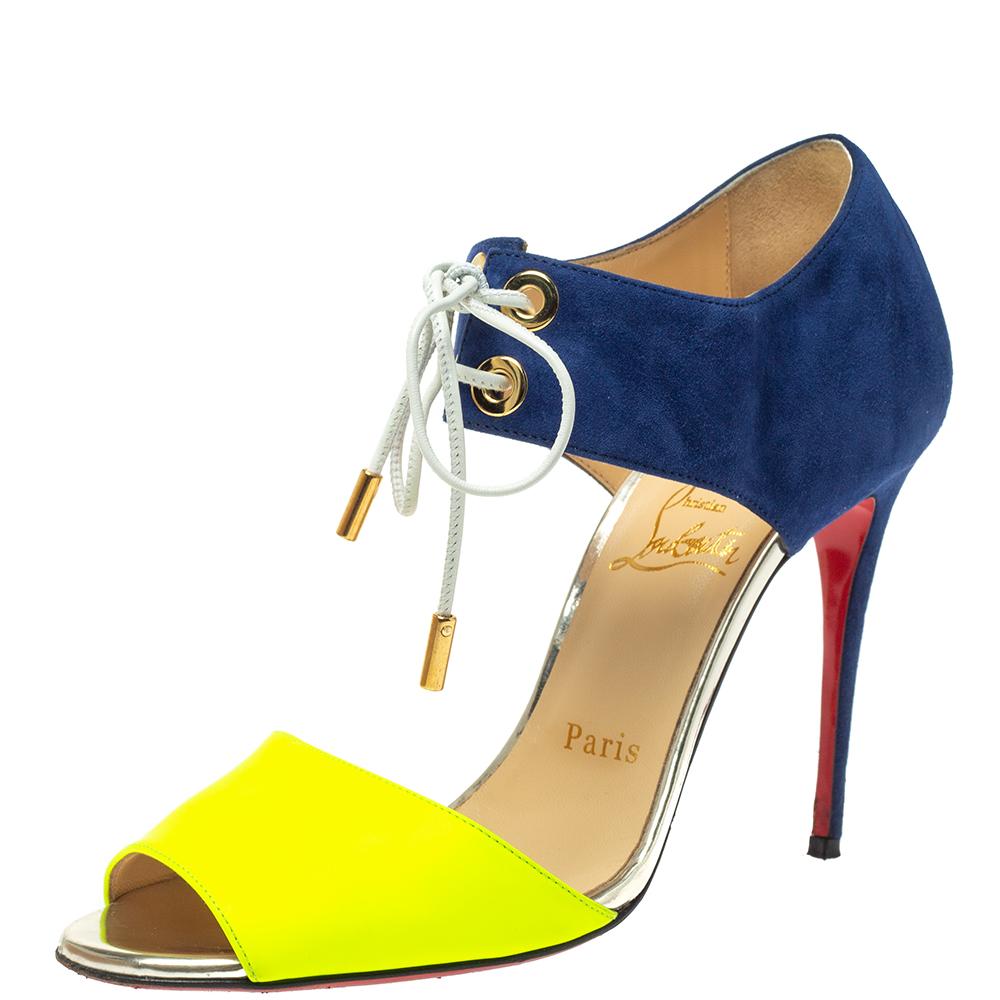 Christian Louboutin's Mayerling stiletto sandals make a bold statement in green leather and navy blue suede. A contemporary design, the cutaway front panel exposes the instep to visibly lengthen the legs, while the lace-up fastening adds a sporty