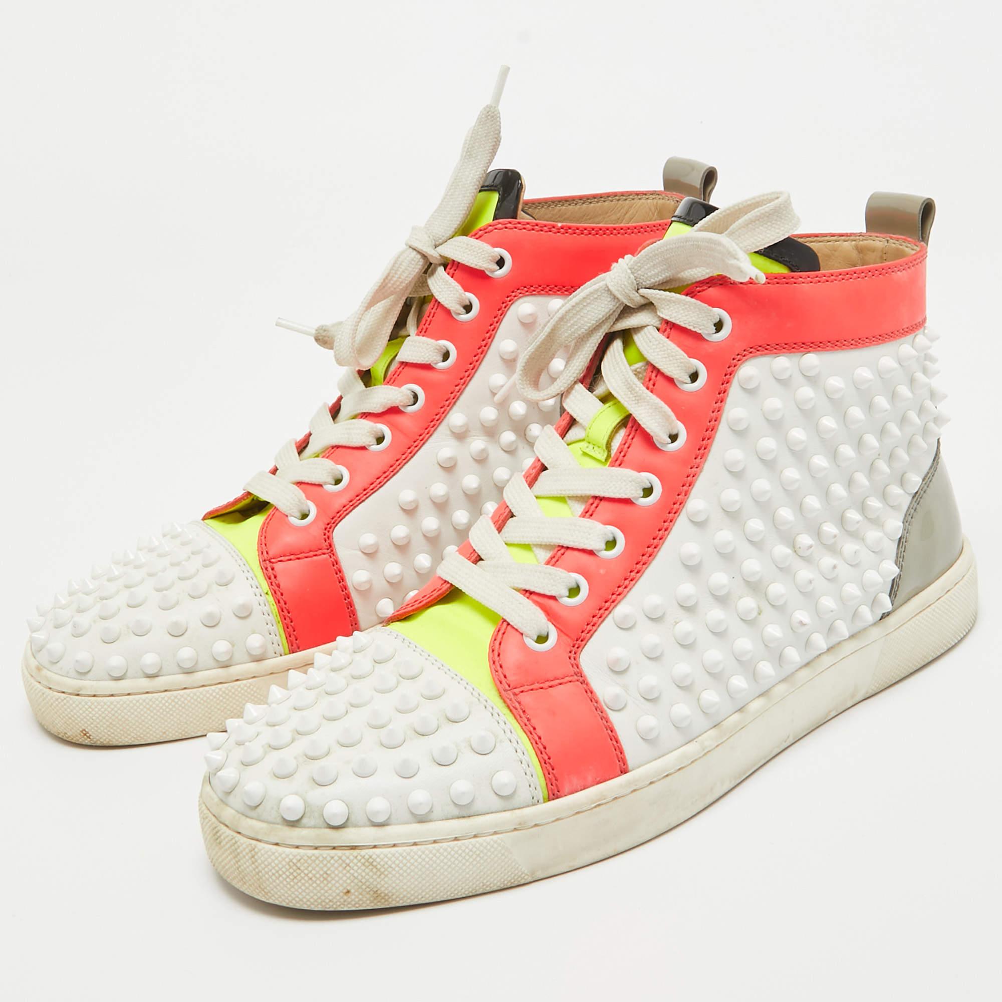Feel great in your casual wear every time you step out in these sneakers from Christian Louboutin. They have been crafted from leather and styled as a high top with an exterior detailed with spikes. The sneakers carry round toes lace up vamps and