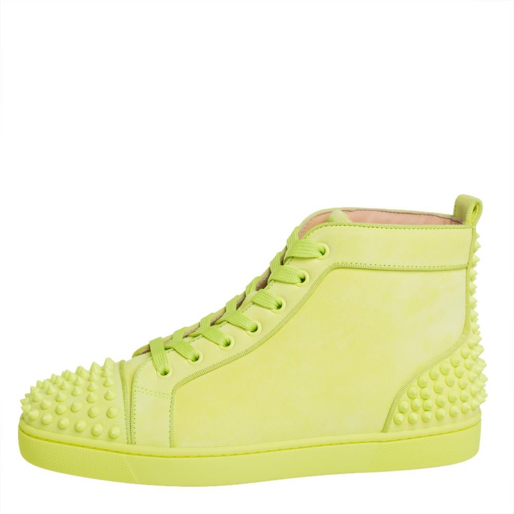 Feel great in your casual wear every time you step out in these sneakers from Christian Louboutin. They have been crafted from neon green suede and styled in a high-top silhouette. The sneakers carry spike embellishments on the round toes and the