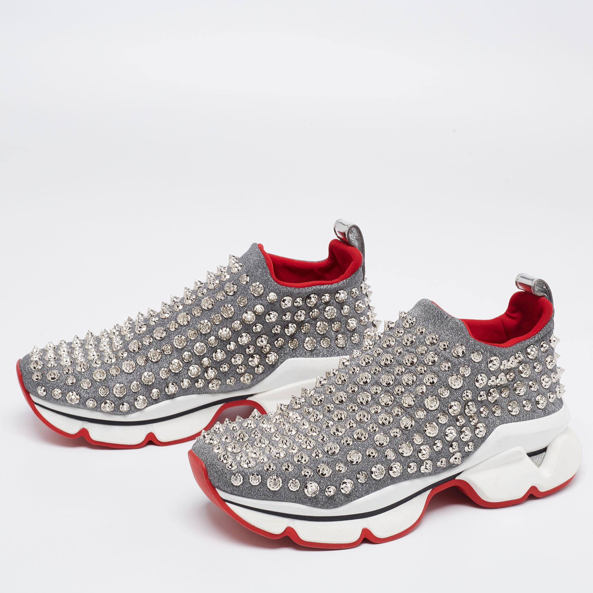 Designed by the house of Christian Louboutin, this pair of sneakers effortlessly elevates your ensemble giving you a trendsetting appearance no matter where you are. These silver sneakers, crafted from premium quality material, feature slightly