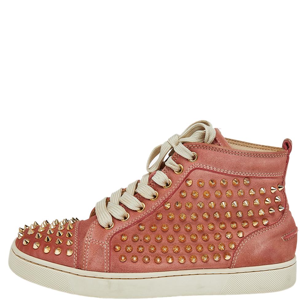 Crafted from nubuck leather into a mid-top silhouette, these Christian Louboutin sneakers show the label's fine craftsmanship in shoemaking. They are detailed with spikes all over and secured with laces on the vamps.
