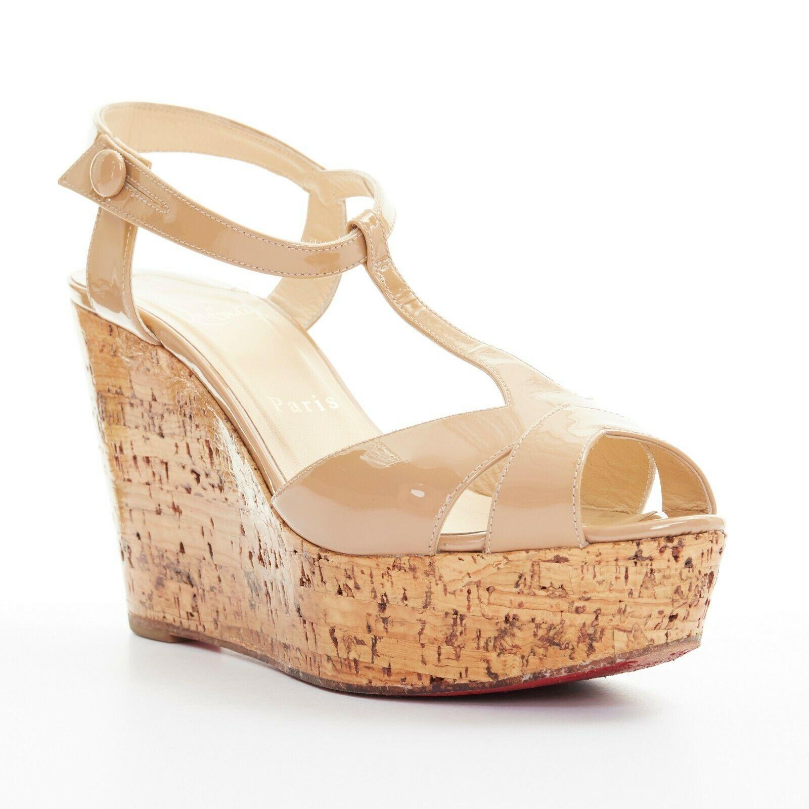 CHRISTIAN LOUBOUTIN nude patent T-strap peep lacquared cork wedge heel EU36.5
CHRISTIAN LOUBOUTIN
Nude patent leather upper. 
Peep toe. T-strap fornt. 
Ankle strap. Button side closure. 
Lacquared cork platform wedge. 
Tonal stitching. Padded tan