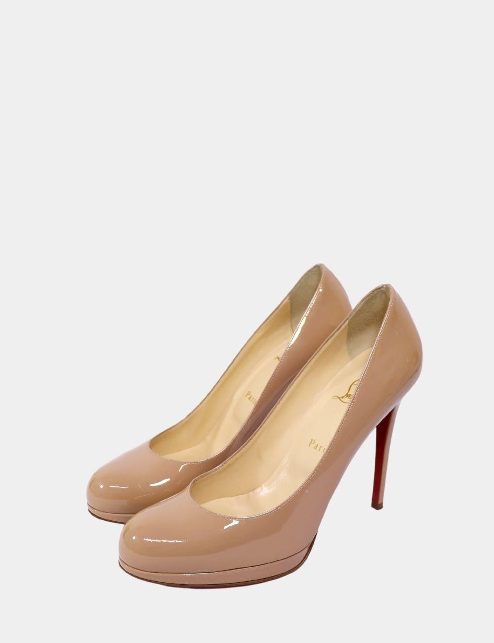 Timeless elegance meets modern edge with the Christian Louboutin Bianca Platform Pumps in glossy nude patent leather. Featuring a rounded toe, sky-high stiletto heel, and subtle platform for added comfort, these pumps are a wardrobe essential. The