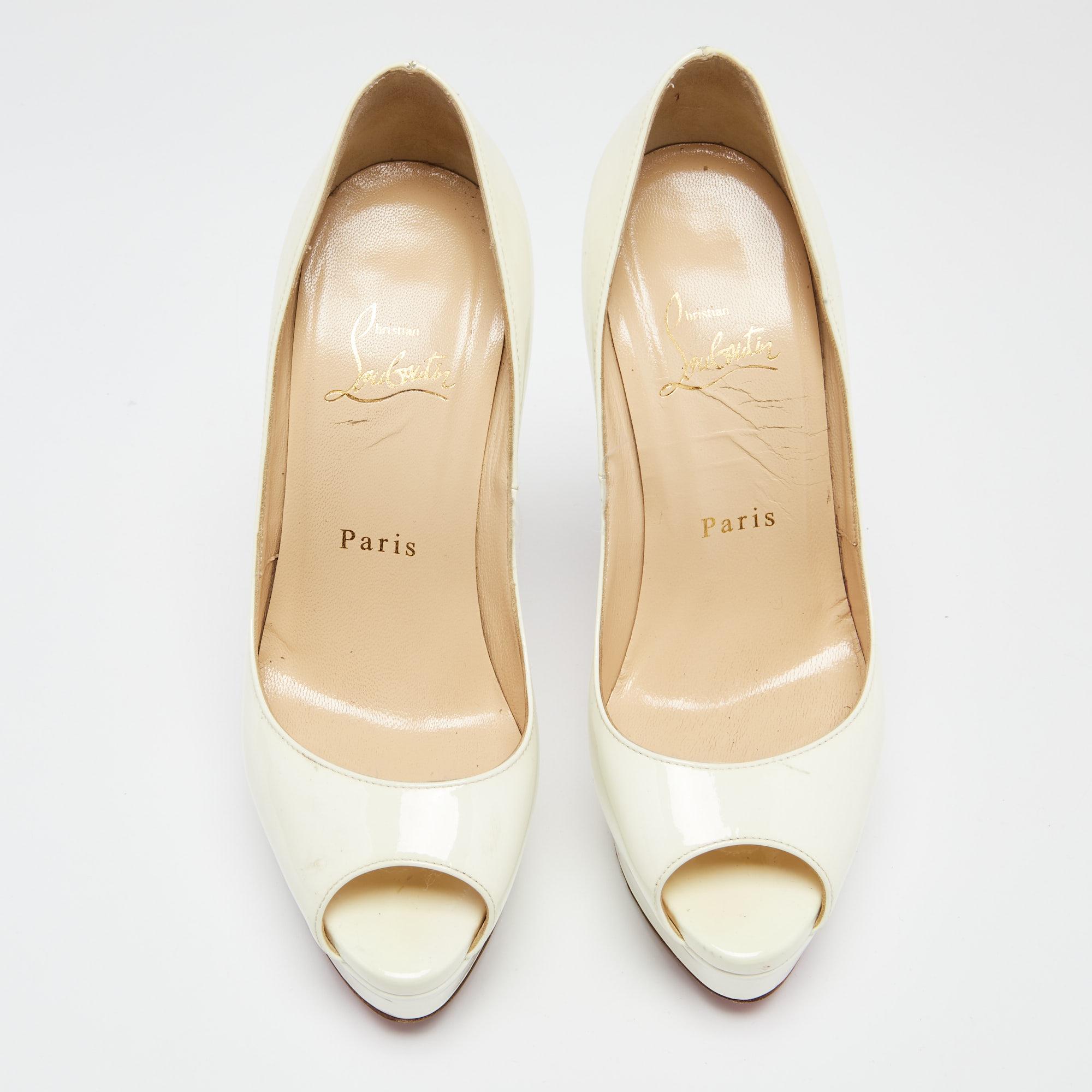 Stand out from the crowd with this gorgeous pair of Christian Louboutin pumps that exude high fashion with class. Crafted from patent leather, this is a creation from their Lady Peep collection. It features a classic white shade with peep toes and a