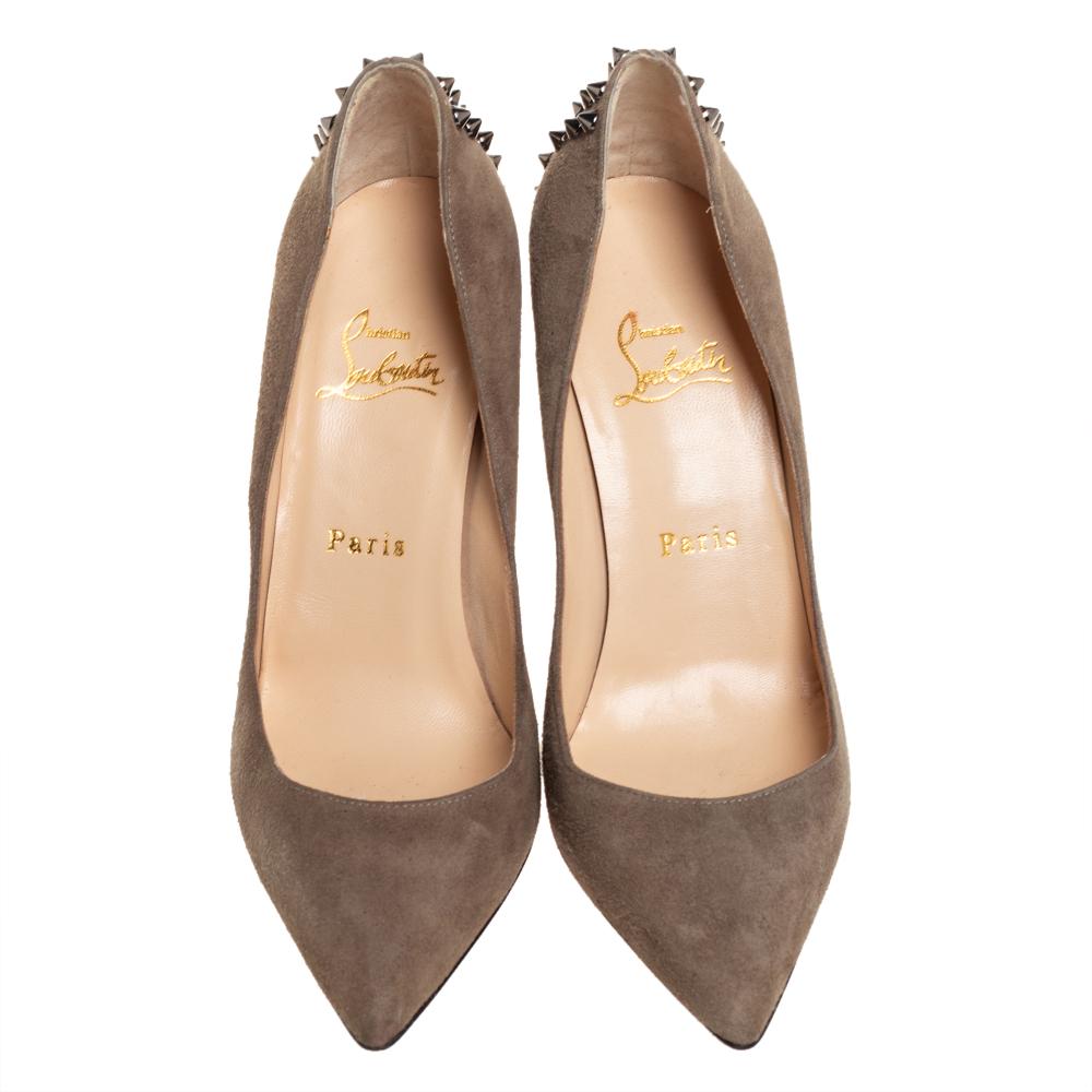 Christian Louboutin yet again brings a stunning set of pumps that makes us marvel at its beauty and craftsmanship. Crafted from suede in an olive green shade, the timeless silhouette is adorned with signature spikes on the counters. The pumps are