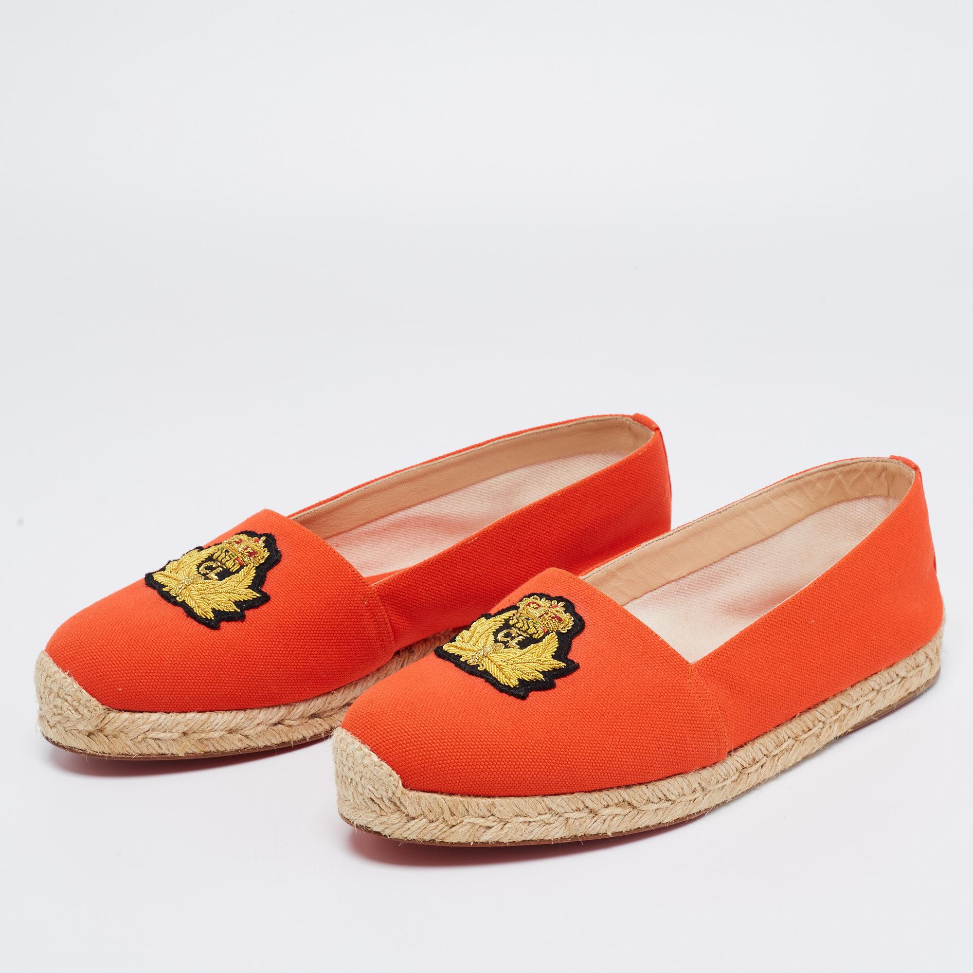 Christian Louboutin brings you these super-stylish espadrilles to achieve an ultimate casual look. They are crafted skillfully using orange canvas on the exterior with an embroidered crest applique decorating the vamps. Their structure is installed