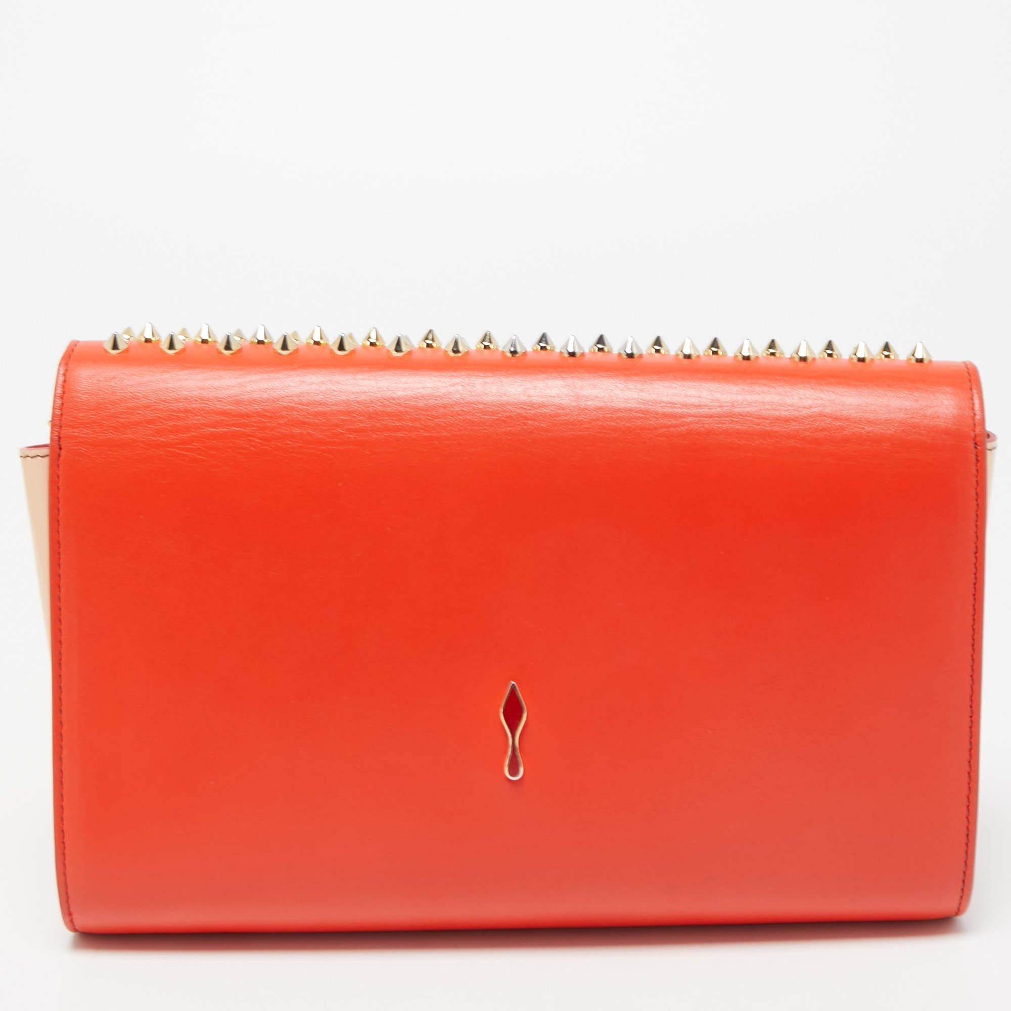 Whether going out for drinks or a casual outing, Christian Louboutin's Paloma clutch is the perfect way to add a little drama to your look. It comes crafted in leather with a flap top embellished with gold-tone spikes. The signature red interior is