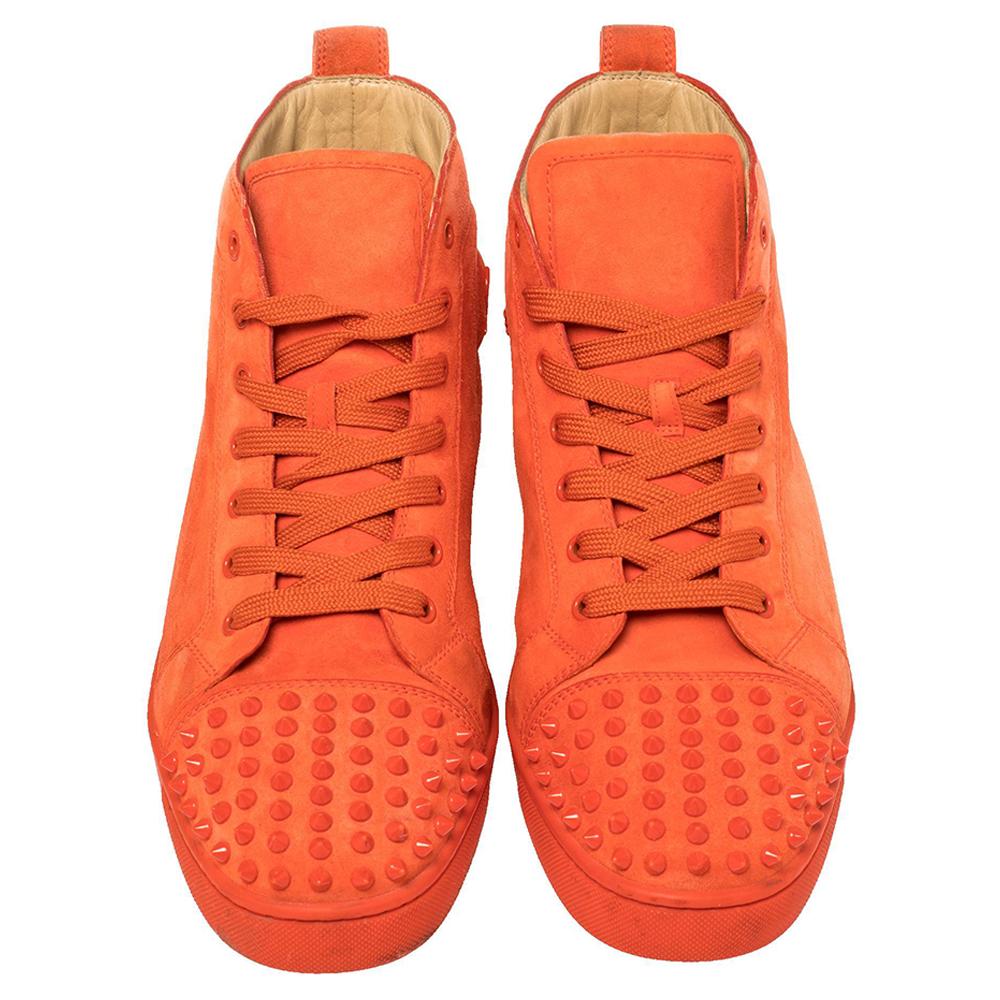 Pull off a stylish look with class in this pair of high-top sneakers from Christian Louboutin. Crafted from orange suede, these sneakers truly embody luxury and comfort. They feature multiple spike embellishments on the round toes, lace-ups on the