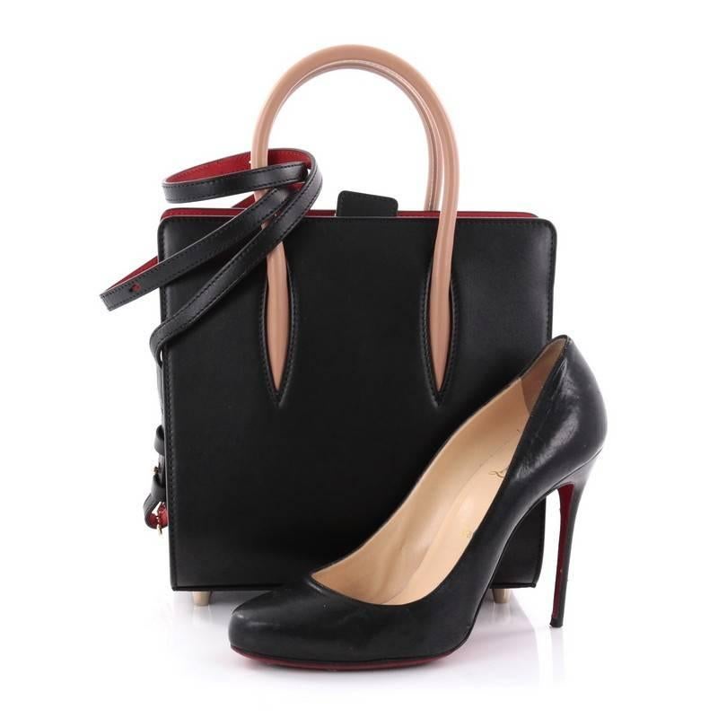 This authentic Christian Louboutin Paloma Tote Leather Small is a unique piece made for avant-garde fashionistas. Crafted in black and red leather, this stand-out daring bag features spiked leopard patent leather on the sides, tall dual-rolled