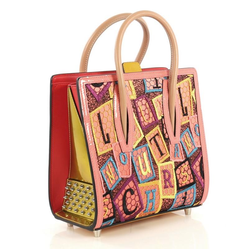This Christian Louboutin Paloma Tote Mesh and Leather Small, crafted in multicolor leather and mesh, features tall dual rolled leather handles, spiked leather on the sides, lettering embroidery, and silver-tone hardware. It opens to a red leather