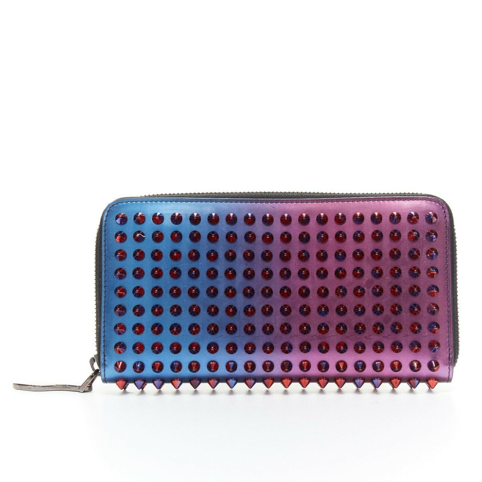 CHRISTIAN LOUBOUTIN Panettone purple blue red metallic ombre leather stud wallet
Designer: CHRISTIAN LOUBOUTIN
Model / Season: Panettone
Material: Leather
Color: blue, purplePattern: ombre
Description: 
Elongated rectangular continental wallet.