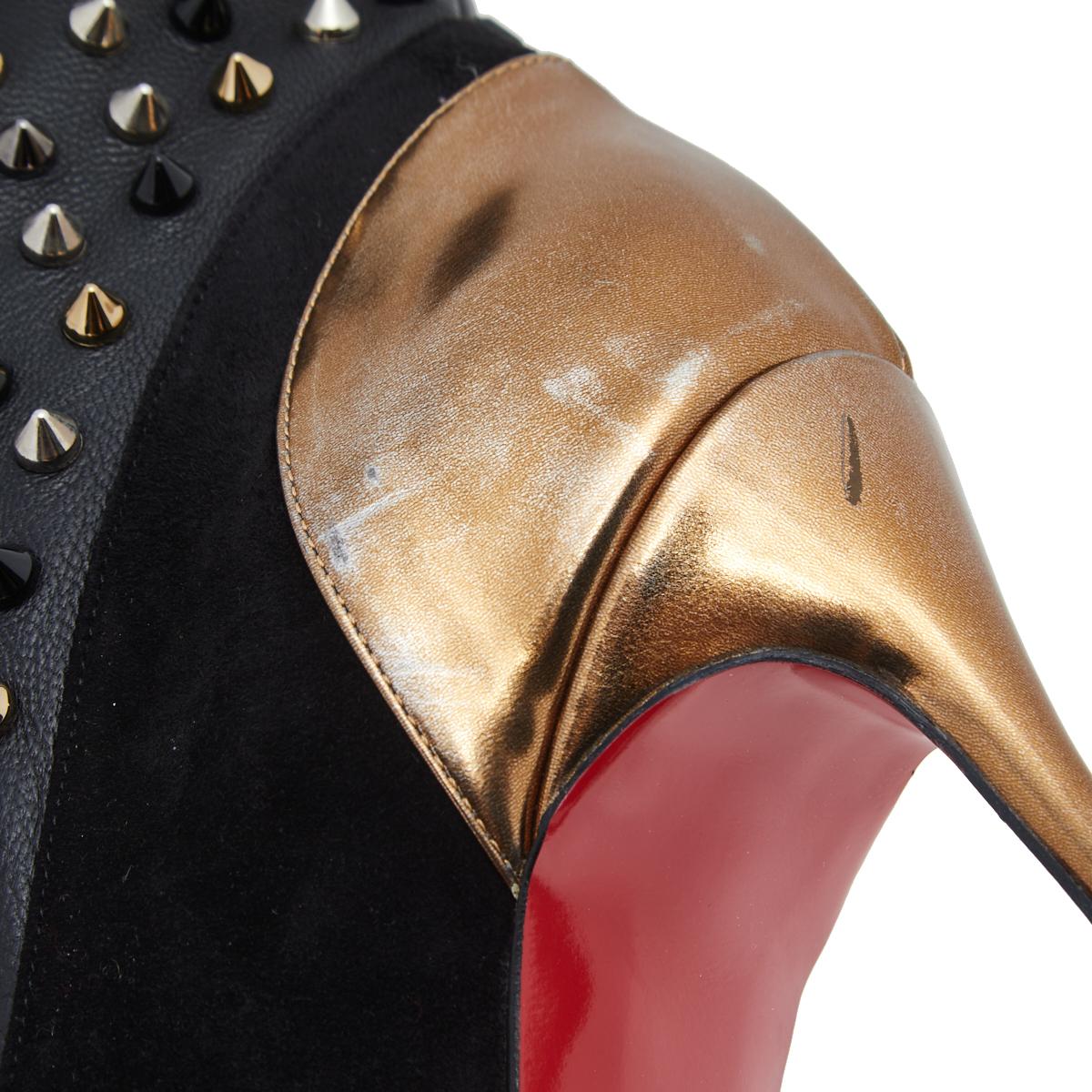 These Spike Wars boots from Christian Louboutin are eye-catching! The black ankle boots are crafted from soft suede and patent leather. They are decorated with spikes and lifted on stiletto heels. The signature red soles complete this fabulous