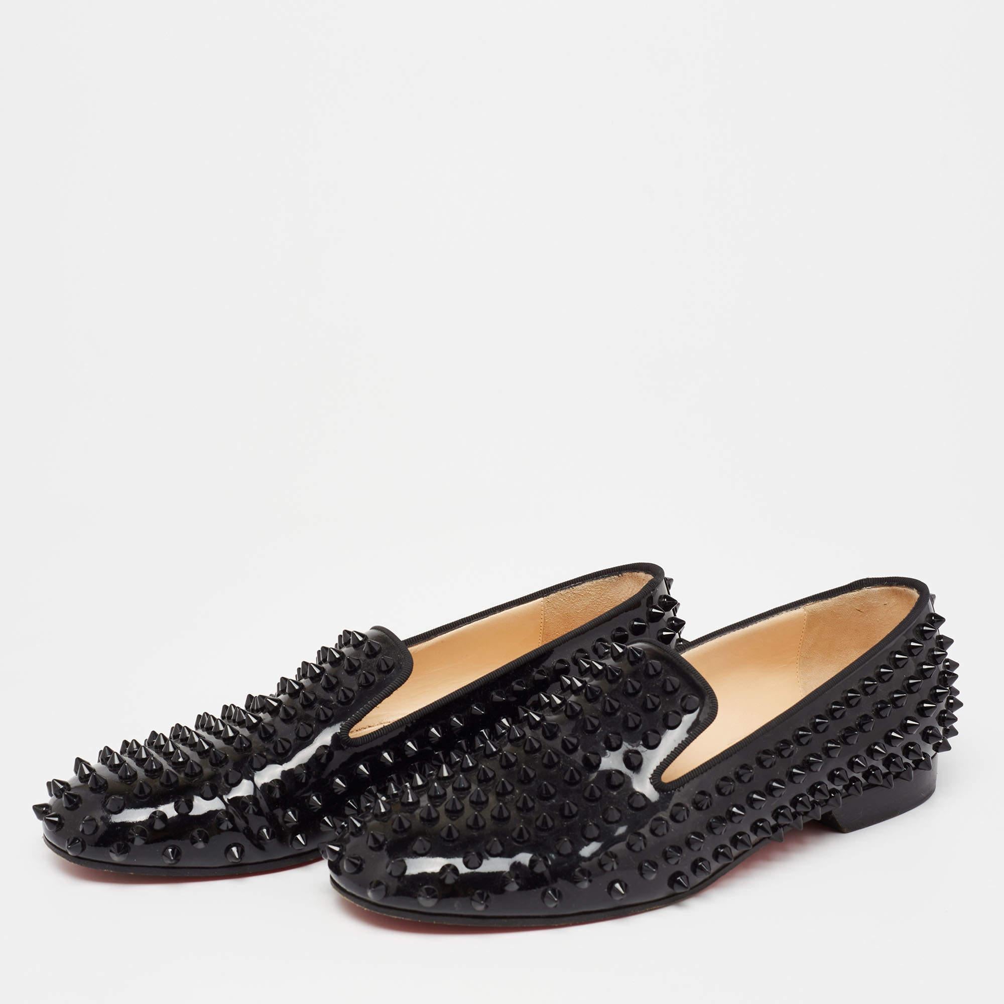 Crafted from black patent leather, these smoking slippers from Christian Louboutin simply stand out! They feature a round-toe silhouette with the signature spike embellishments adorning the exterior. They are complete with comfortable leather-lined