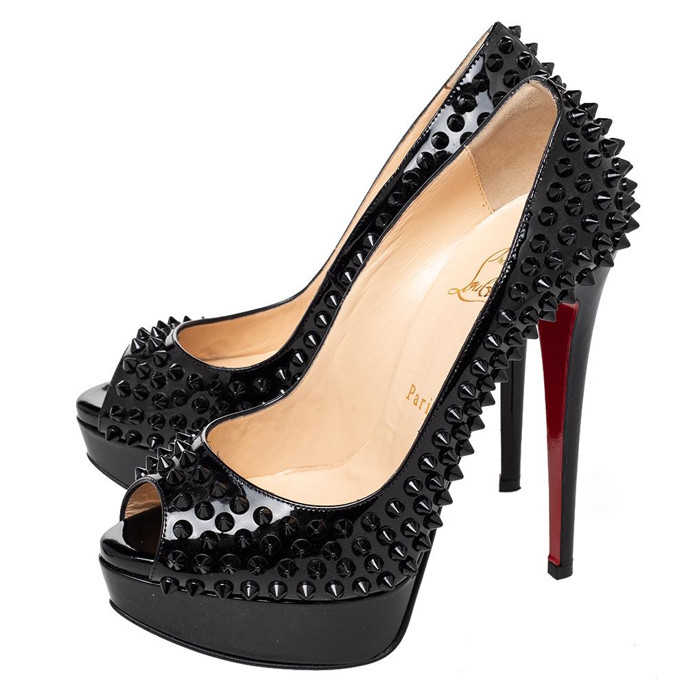 Make a statement in this pair of Christian Louboutin pumps! Crafted from patent leather, this is a creation from their Lady Peep collection. The pumps feature a black shade with peep toes and a spike-embellished exterior. Completed with leather