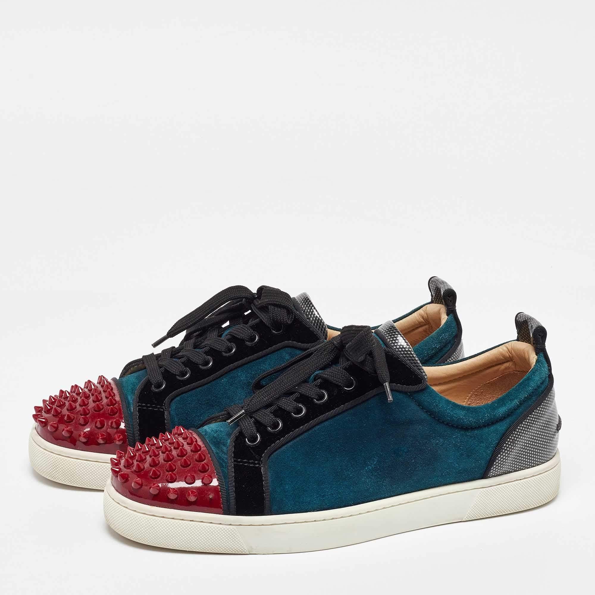 These sneakers from Christian Louboutin. They have been crafted from velvet along with patent leather and styled in a low top silhouette. The sneakers carry spike embellishments on the exterior round toes lace ups on the vamps pull tabs on the