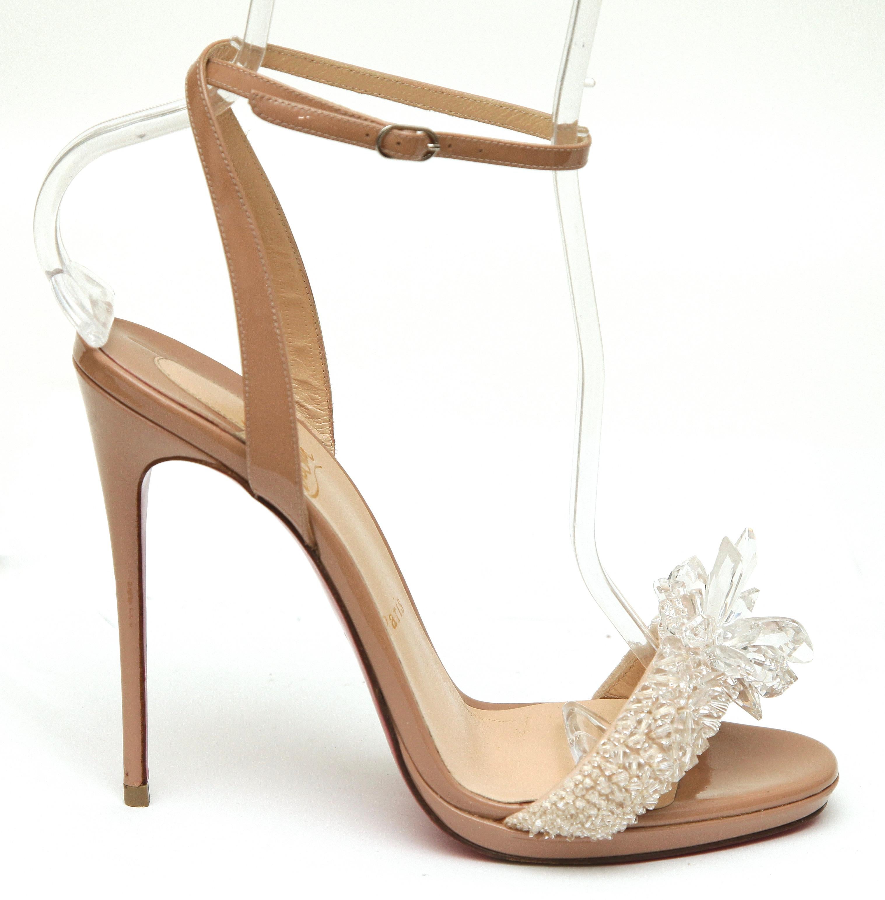 CHRISTIAN LOUBOUTIN CRYSTAL QUEEN EMBELLISHED SANDALS


Details:
- Patent leather in a nude-blush color.
- Embellished crystal strap over vamp.
- Almond toe.
- Ankle strap with buckle closure.
- Self covered heels.
- Leather lining and sole.
- Comes
