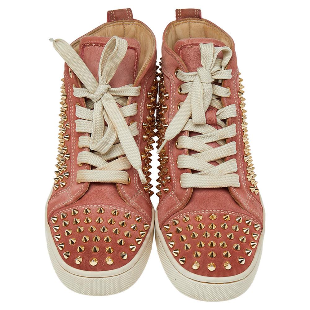Crafted from nubuck leather into a mid-top silhouette, these Christian Louboutin sneakers show the label's fine craftsmanship in shoemaking. They are detailed with spikes all over and secured with laces on the vamps.


