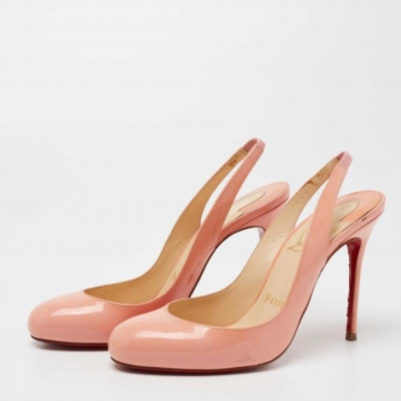 Minimal in design, this pair of Fifi pumps from Christian Louboutin is defined by its smooth curves and precise lines. Crafted from patent leather in a peach pink shade, it features a structured shape, signature red-lacquered soles, and a