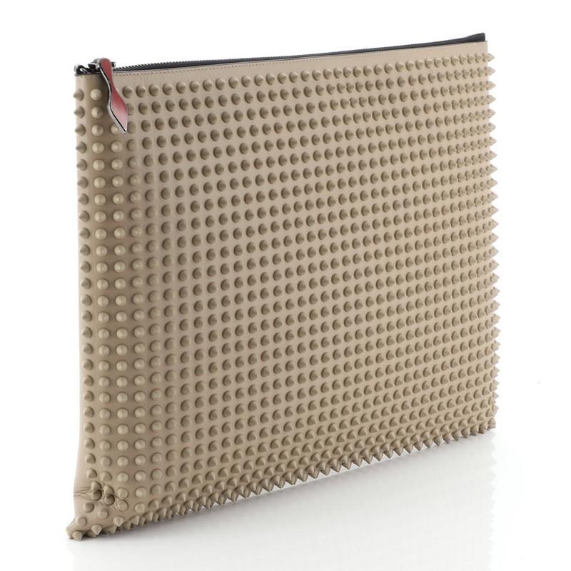 This Christian Louboutin Peter Pouch Spiked Leather Medium, crafted from neutral spiked leather, features a wristlet strap, exterior back zipThis Christian Louboutin Peter Pouch Spiked Leather Medium, crafted from neutral spiked leather, features a
